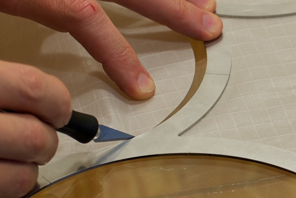 cutting circles from fabrics like dacron and other synthetics cutting ripstop nylon circles closeup with xacto knife