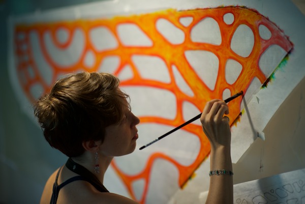 Ruth Whiting painting a test for a colorwing morpho glider