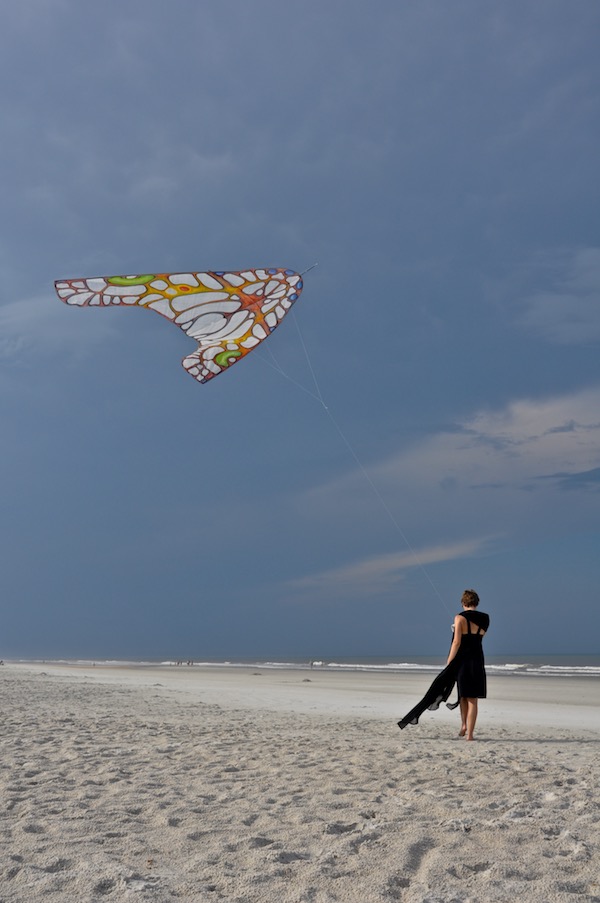Ruth Whiting walking with a ColorWing Morpho Glider kite at anastasia beach florida