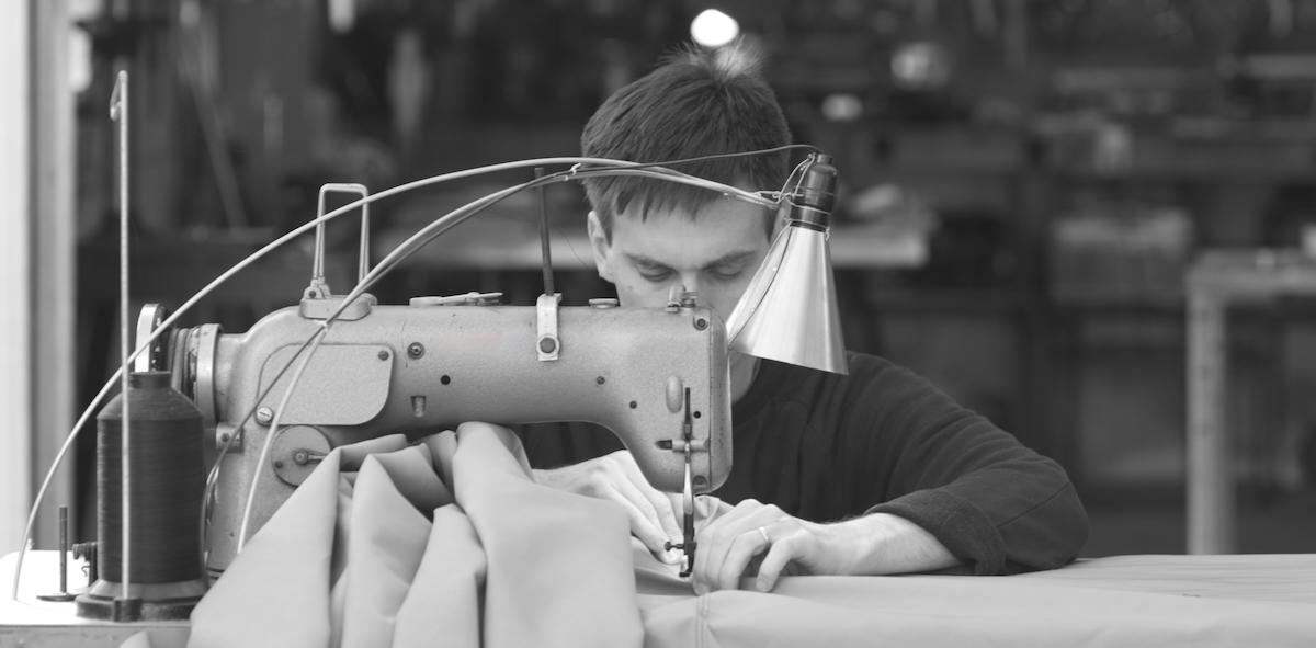 Tim Elverston sewing a kite repair for a customer