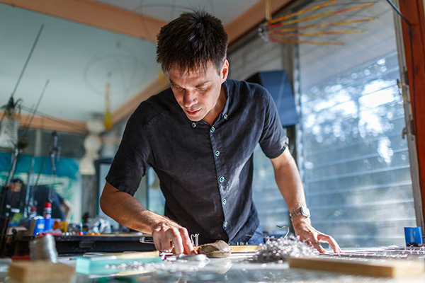 Tim Elverston working on kinetic art in the WindFire Designs studio