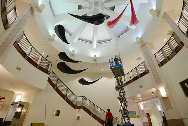 Tim Elverston and Ruth Whiting installing the Flowx piece at UF Engineering