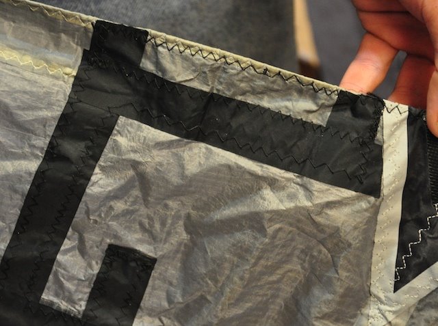 Square-cornered patch and rough stitching from a poorly executed kite repair