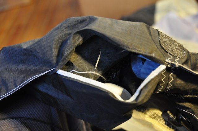 Sewing machine mid-repair on the opened leading edge closure seam