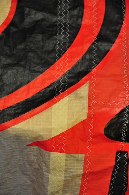 Close-up of the repaired rip through three lines of stitching on a Cabrinha kite