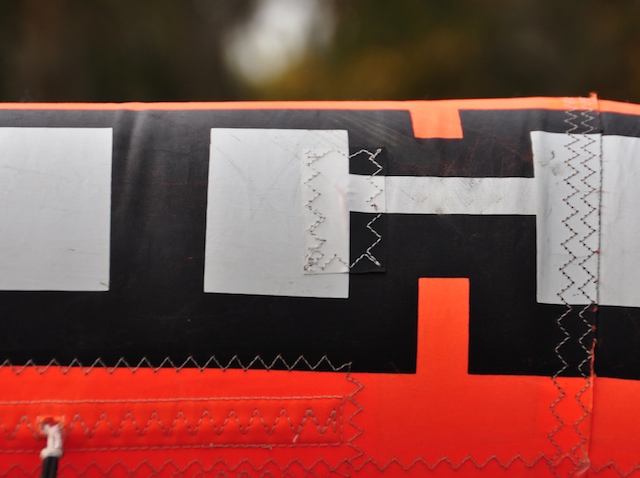 Hidden patch sewn into the Cabrinha name on the leading edge
