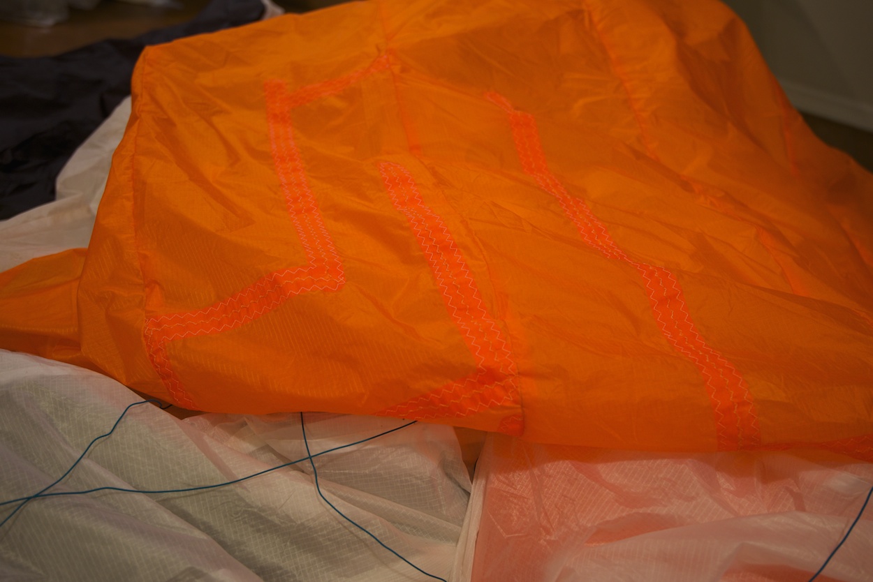 Dudek Nemo paraglider repair by WindFire Designs — close-up of fiber alignment during patch repair