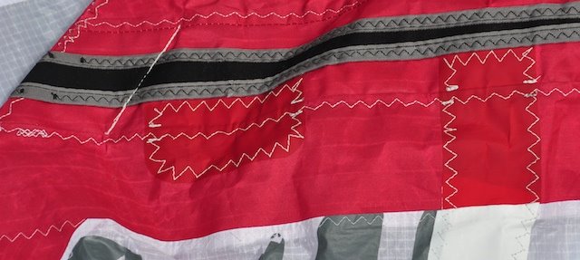 F-One kite leading edge repair showing staggered patches along the tube