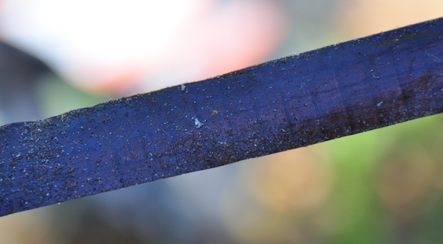Second sample of ripstop repair tape residue showing sand and gummy adhesive