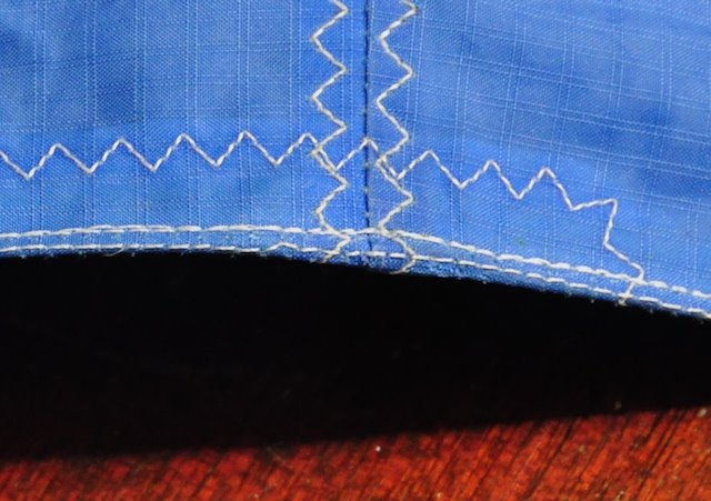 Repaired Cabrinha leading edge showing factory stitching next to WindFire's triple step zigzag closure seam