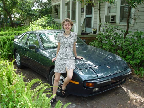 My hot wife leaning against a Porsche
